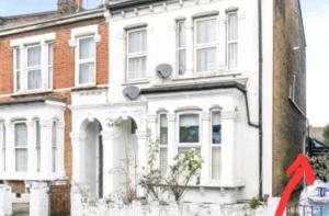 a red arrow pointing to a white house at Room with luxury private bathroom, independent entrance, near Tube in London