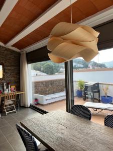 a chandelier in a room with a table and chairs at Big family house in the Center of el port de la selva in Port de la Selva