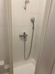 a shower with a shower head in a bathroom at Rooms Jelena in Dubrovnik +36 photos