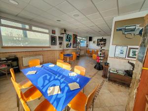 a dining room with a blue table and chairs at Hostería Sol in San Miguel de Meruelo