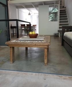 a wooden table with a bowl of fruit on it at Premium Loft of the Fountain Small Plaza w/Netflix in Buenos Aires