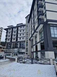 a group of tall buildings in the snow at Gondola Mako Exclusive in Zlatibor
