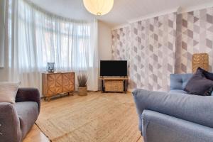 a living room with two couches and a television at West Midlands Contractor - LongStay - Parking - 4 Beds - Pet Friendly in Sleightholme