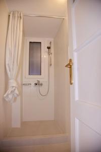 a bathroom with a shower with a shower curtain at Aroura Neoclassical Home 3BR 2BA in Athens