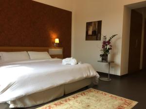 Postel nebo postele na pokoji v ubytování Grande Albergo Alfeo