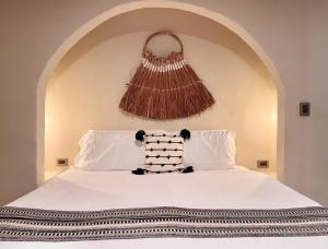 a white bed with a pillow on top of it at Xaman - Boutique Studios in Cancún