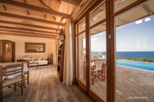 a living room with a view of the ocean at Blue Caves Villas - exceptional Villas with private pools direct access to the sea in Koríthion