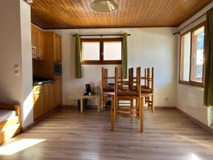 a kitchen with a table and chairs in a room at Appartement EDELWEISS in Châtel