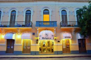 a large building with a clock on the front of it at Boutique Hotel Belgica in Ponce