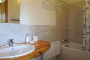 a bathroom with a sink and a bath tub at Gîte CAMPANULES - 5 personnes - "Les Gites du Chalet" à Autrans in Autrans