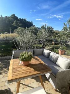 a couch sitting on a patio with a wooden table at Casa Fumica Apartment in Palit