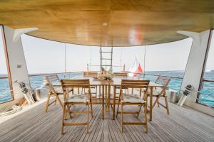 een tafel en stoelen op het dek van een boot bij Spacious 24Meters Long Yacht Lagaro / 5 Cabins in Ibiza-stad