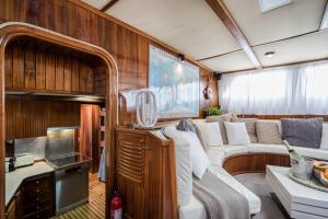 a living room with a couch in a boat at Spacious 24Meters Long Yacht Lagaro / 5 Cabins in Ibiza Town