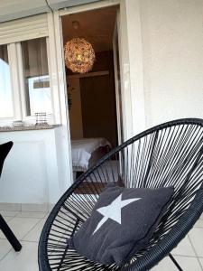 a black chair with a pillow with a star on it at Casa Fumica Studio in Kampor