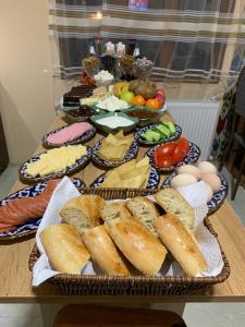 a table topped with different types of bread and vegetables at OLD SAFARI HOTEL make yourself at home in Bukhara