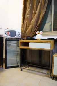 een bureau met een televisie en een tafel met een raam bij ستوديوهات دانيال Daniel Studio in Ramallah