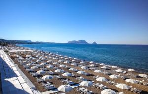 een stel parasols en stoelen op een strand bij mdresort villa fronte mare in Trabia