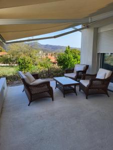 a group of chairs and tables on a patio at Country Cottage in Dafni, Limni in Limne