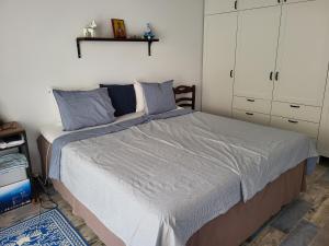 a bedroom with a large bed with blue pillows at Country Cottage in Dafni, Limni in Limne