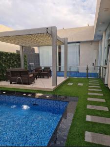 una casa con piscina en el patio en شاليهات بالي ان الفندقية, en Yeda