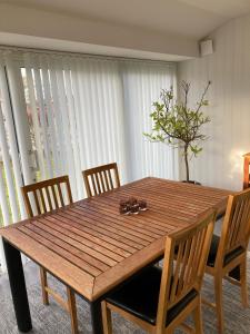 uma mesa de jantar com cadeiras e uma mesa de madeira em Långasand em Heberg