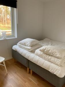 uma cama não feita num quarto com uma janela em Långasand em Heberg