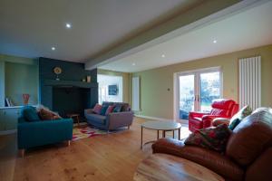 a living room with a couch and chairs and a table at Unique 5BD Farm House Perfect for Relaxing in Ipswich