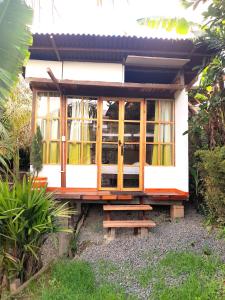 a small house with wooden doors and windows at Hostal Estrella de Agua in Salento