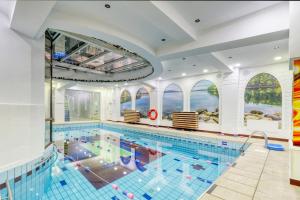 a large indoor pool with a large swimming pool at Luxurious 3 Bedroom Apartment in Herastrau in Bucharest