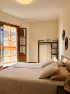 a bedroom with a large bed and a window at Apartamento Palacio de Las Sevillanas in Haro