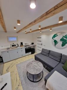 a living room with a couch and a table at R&J Guesthouse Apartment in Grindavík