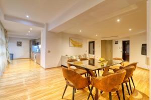 una sala da pranzo con tavolo e sedie di Luxurious 3 Bedroom Apartment in Herastrau a Bucarest