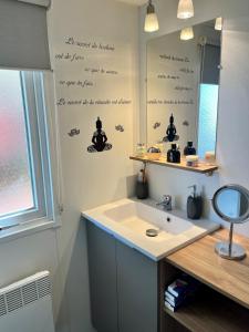 a bathroom with a sink and a mirror at Mobile home Zen Siblu Fréjus in Fréjus