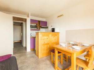 a kitchen and dining room with a wooden table at Studio La Rosière, 1 pièce, 4 personnes - FR-1-275-139 in La Rosière