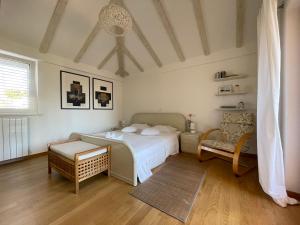 een slaapkamer met een bed en een stoel bij Holiday Residence Zvono in Mlini