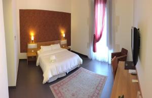Postel nebo postele na pokoji v ubytování Grande Albergo Alfeo