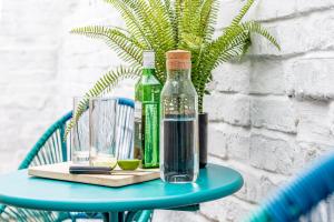 a blue table with two bottles of water on it at 3 bedroom home sleeps 5 close to Chester City Centre welcomes couples, small groups, families and contractors in Chester