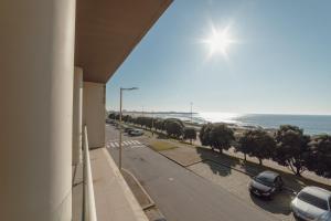 a building with a view of a road and the ocean at Modern Grand Seaside & Seaview by Vacationy in Matosinhos