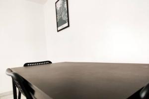stół z dwoma krzesłami i zdjęciem na ścianie w obiekcie Spacieux T2 proche tribunaux w mieście Douai