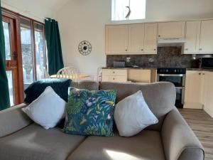 a couch with pillows on it in a kitchen at Irfon Cottage in Builth Wells