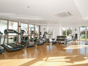 a gym with treadmills and elliptical machines at Cotswolds Lake side home with luxury spa Swallows Nest,Lower Mill Estate, Lakeside home/spa in Somerford Keynes