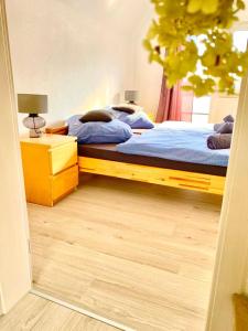 a bedroom with two beds and a wooden floor at Ferienhaus zur Donau in Herbertingen