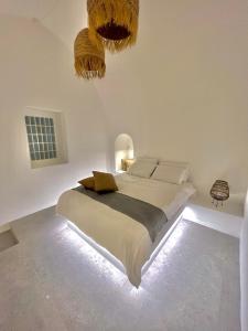 una camera da letto con un grande letto illuminato di Saba Luxury Suites a Karterados