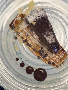 a piece of chocolate cake sitting on a plate at Sandaya Luxury Suites in Naousa
