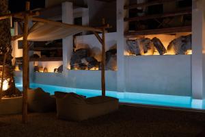 a room with rocks on a wall with blue lights at Sandaya Luxury Suites in Naousa