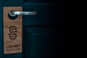 a door with a do not disturb sign on it at Sandaya Luxury Suites in Naousa