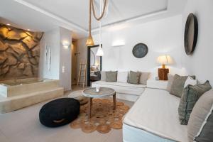 a living room with a couch and a table at Sandaya Luxury Suites in Naousa