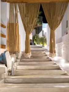 a set of stairs with curtains on them at Sandaya Luxury Suites in Naousa