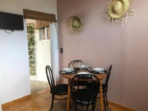 a dining room with a table and some chairs at Apartamentos Océano in Samieira