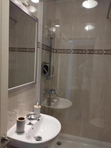 a bathroom with a white sink and a shower at Casa SolyMar Canarias 6 in Caleta De Fuste